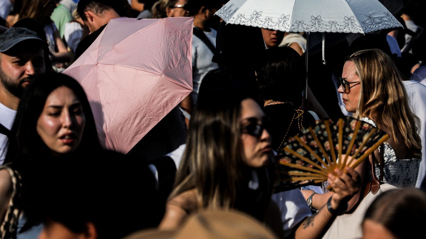 Crowds during a red heatwave alert near the Louvre in Paris, Ile-de-France, France, July 12, 2026.